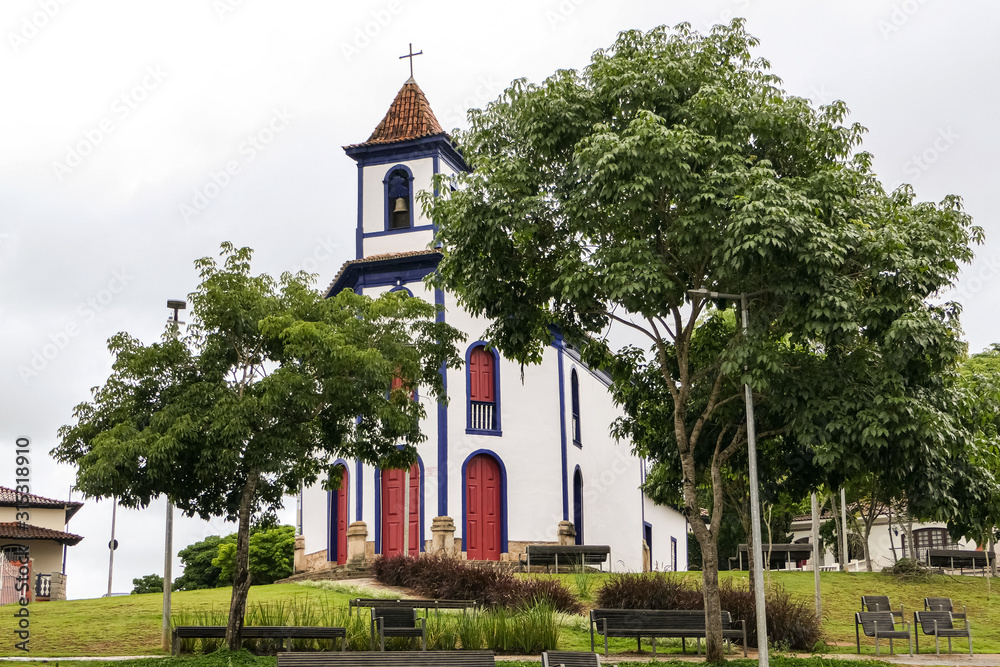 Colonial church framed by trees and cloudy background, Santa Barbara, Brazil
