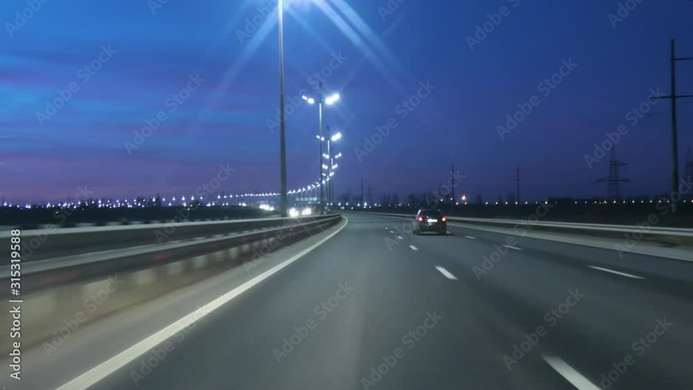 Driving Car POV On Freeway In Of Night In With Little Traffic After Sunset. Evening Sunset Street Lights. Night, Camera In Front, Windshield Reference. Driving Car On Highway At Dark 4K POV.