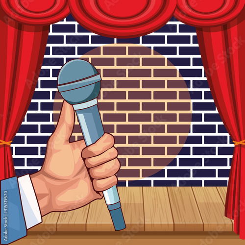 hand with microphone stage wall brick stand up comedy show