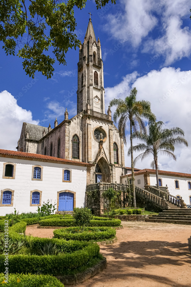 View to church and buildings with blue sky and white clouds, Sanctuary Caraça, Minas Gerais, Brazil