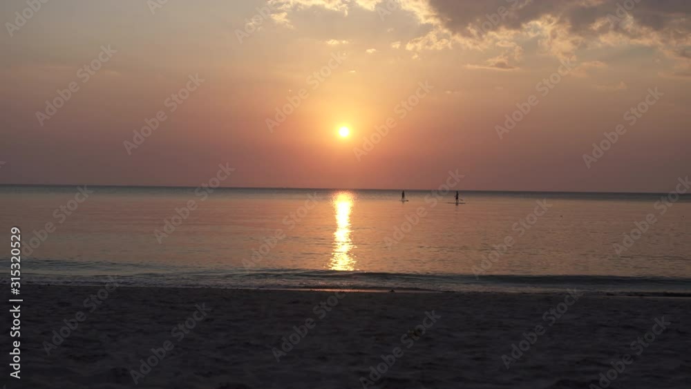 Stand Up Paddle Boards Silhouette on Water at sunset in Andaman Sea, thailand Stand Up Paddle Boards Silhouette on Water at sunset in Andaman Sea, thailand