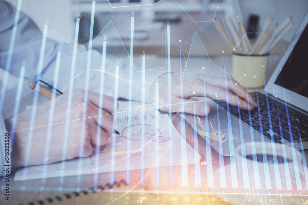 Multi exposure of stock market graph with man working on laptop on background. Concept of financial analysis. Multi exposure of stock market graph with man working on laptop on background. Concept of financial analysis.