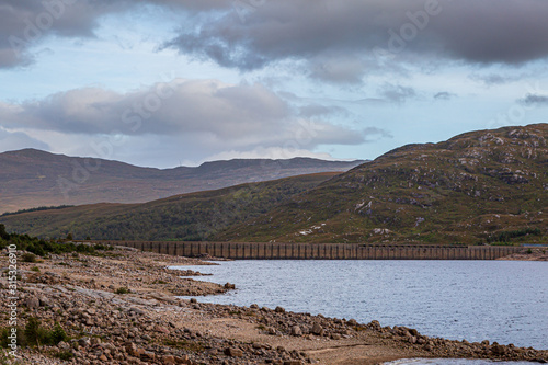 The dam at Loch Cluanie in the Scottish Highlands, on a late summers evening photo