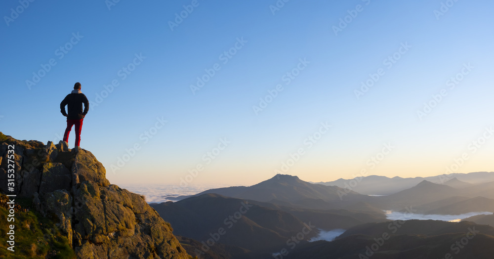 Man on a mountain top observing the landscape, Aiako Harriak Natural Park, Euskadi