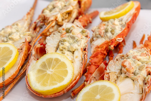Spiky Lobster. Half lobster stuffed with salad and lemon wedges.