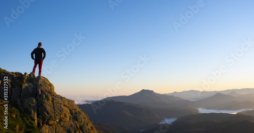 Man on a mountain top observing the landscape  Aiako Harriak Natural Park  Euskadi