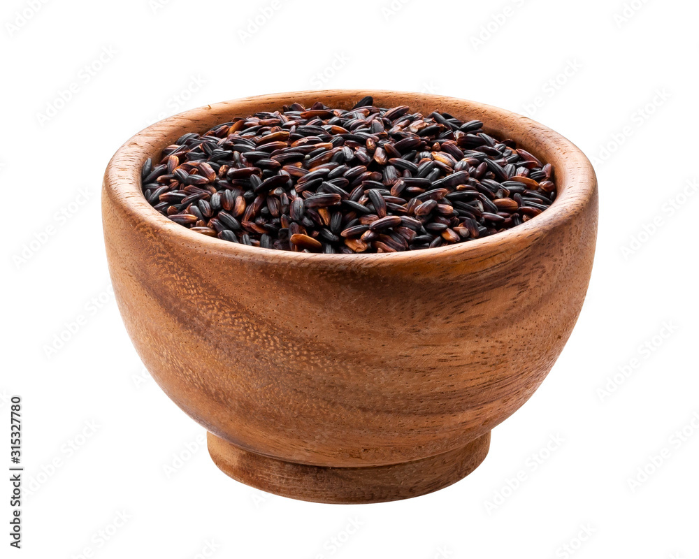 Black rice in wooden bowl isolated on white background Black rice in wooden bowl isolated on white background