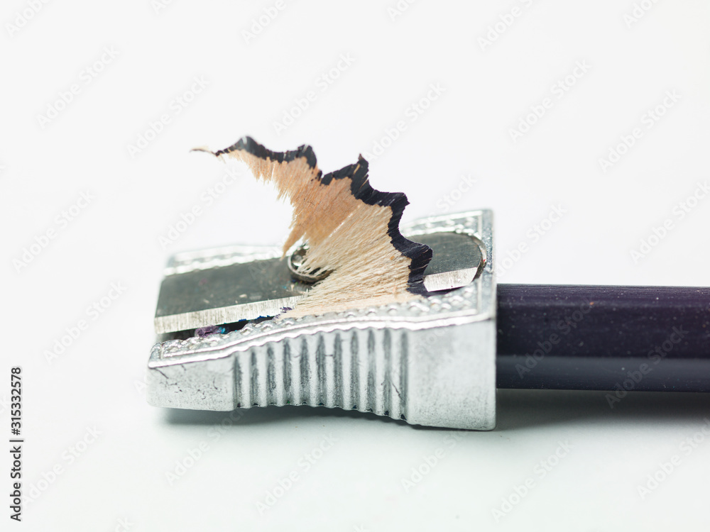 colored pencil in sharpener, white background and copy space colored pencil in sharpener, white background and copy space