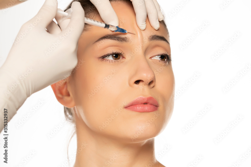 Portrait of a young beautiful woman on a face filler injection procedure