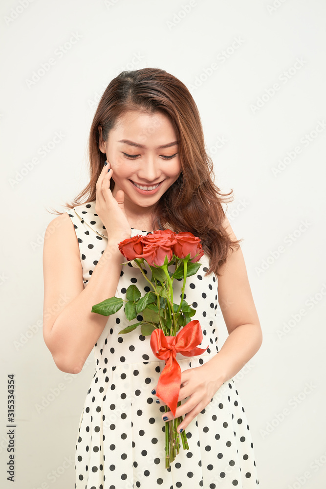 Beautiful woman holding bouquet of roses. Smiling and looking at camera. Front view Beautiful woman holding bouquet of roses. Smiling and looking at camera. Front view
