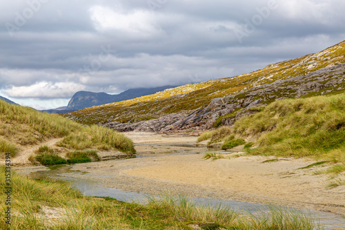 Mountains and sand dunes on the way to the beach, at Luskentyre on the Hebridean island of Harris