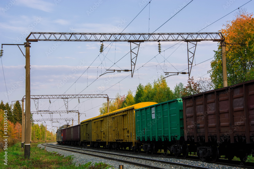 Railroad cars loaded with coal. Freight train. Colored wagons on the railway. Railroad cars loaded with coal. Freight train. Colored wagons on the railway.