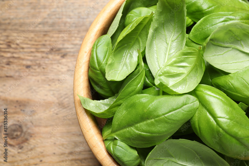 Fresh basil on wooden table, top view Fresh basil on wooden table, top view