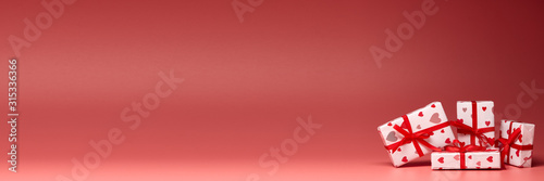 Gift boxes on pink background with copy space. Valentine's Day. Extra wide panorama banner background