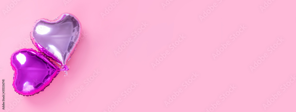 Valentine's Day romantic design concept - Beautiful real heart shape foil balloon isolated on pale pink background, top view, flat lay, overhead above photography. Valentine's Day romantic design concept - Beautiful real heart shape foil balloon isolated on pale pink background, top view, flat lay, overhead above photography.