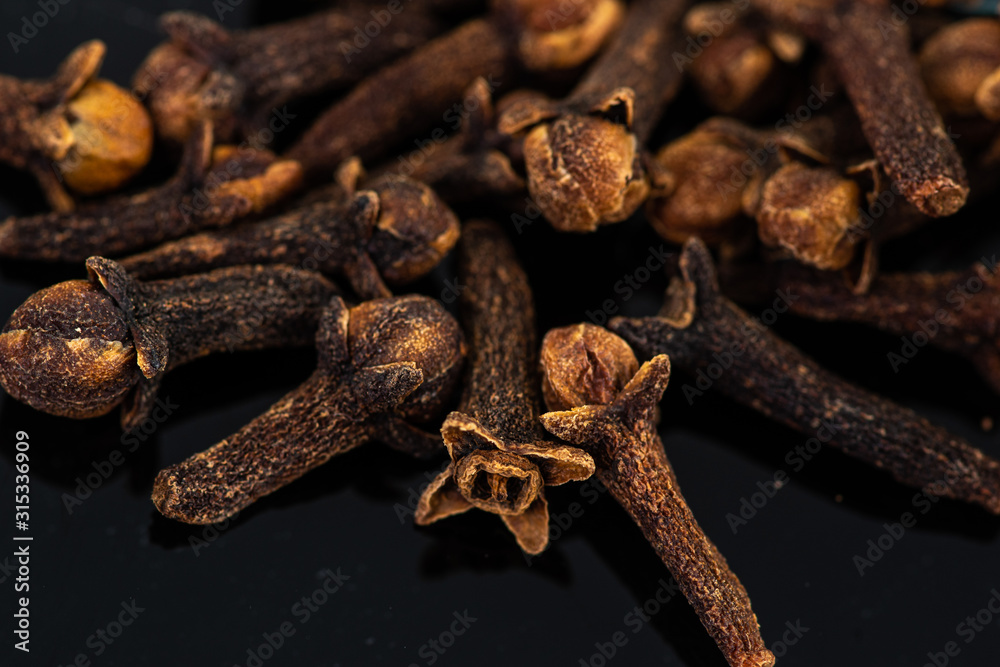 dried clove spice next to test tube and cork dried clove spice next to test tube and cork