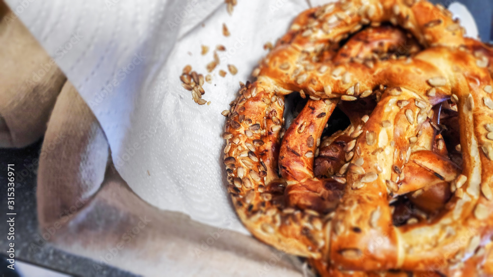 Delicious fresh pretzels with sesame seeds put in a basket