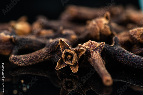 Fototapeta Naklejka Na Ścianę i Meble -  dried clove spice next to test tube and cork