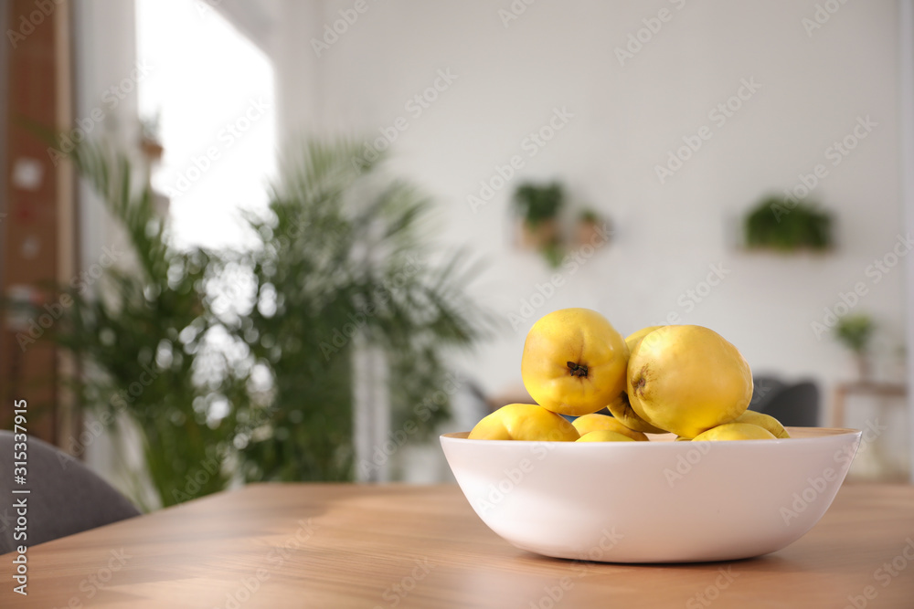 Ripe quinces on wooden table at home Ripe quinces on wooden table at home