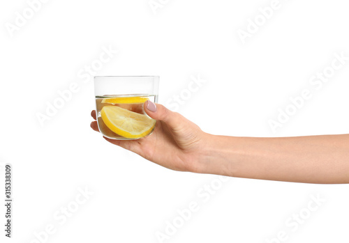 Woman with tasty lemon water on white background, closeup