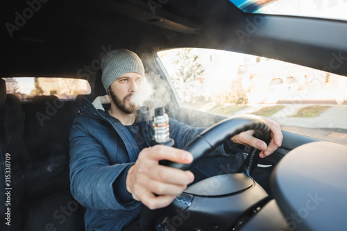 Vaping an electronic cigarette whilst driving in car
