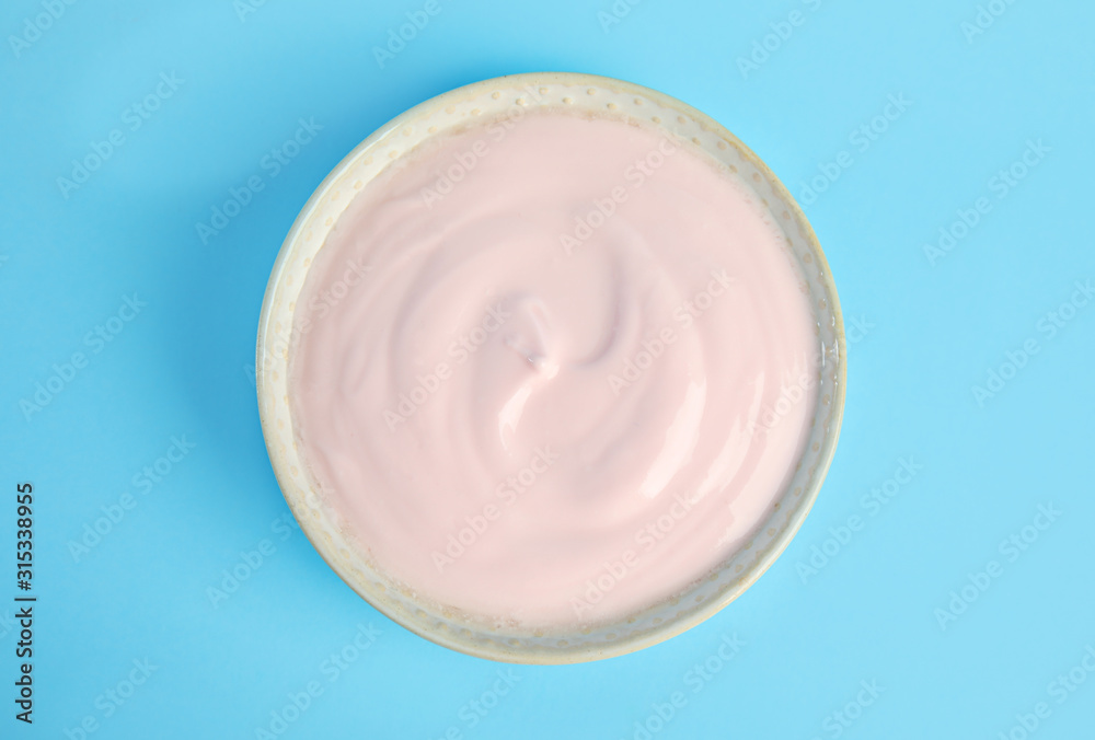 Tasty organic yogurt on light blue background, top view Tasty organic yogurt on light blue background, top view