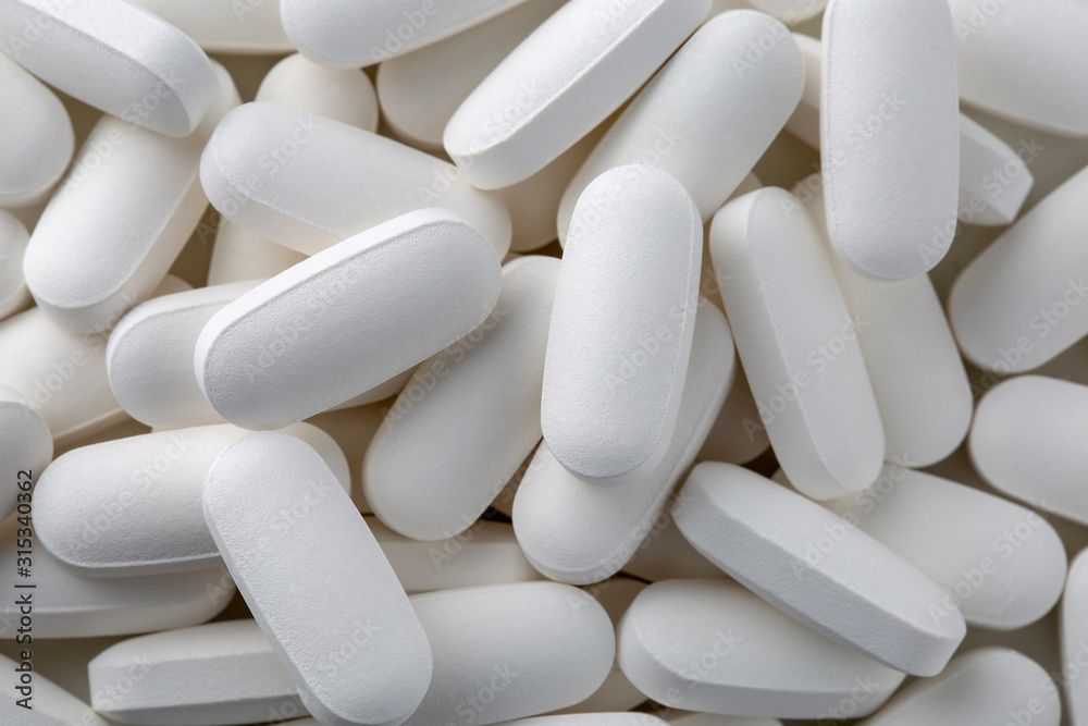Pills tablets vitamins drugs white close up macro shot Pills tablets vitamins drugs white close up macro shot
