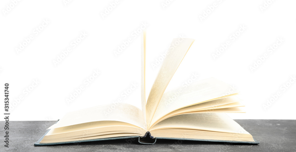 Fototapeta premium Open book on grey stone table against white background