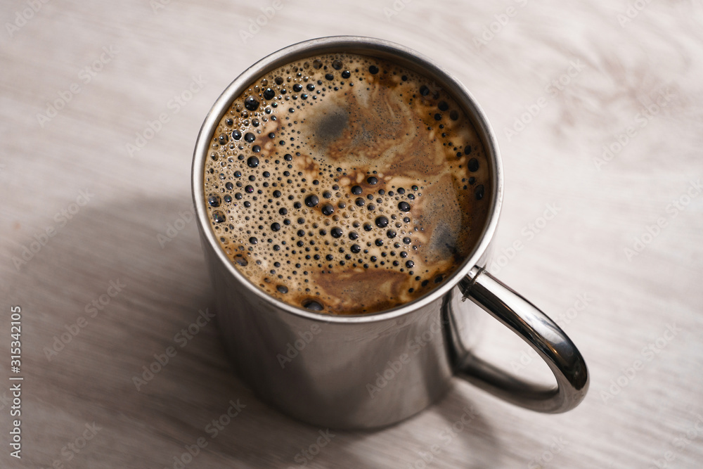 Centered metallic cup of instant coffee Centered metallic cup of instant coffee