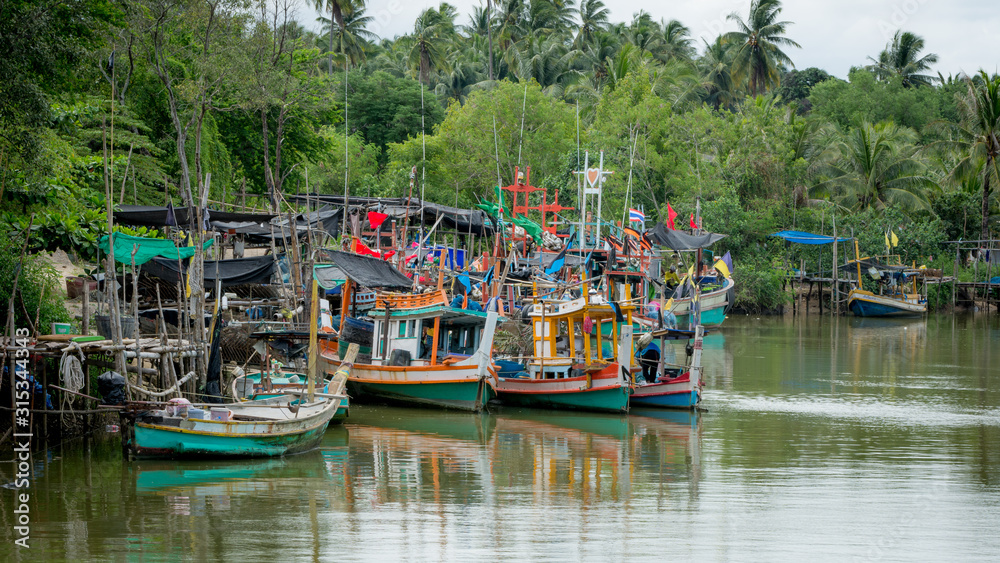 Thai fishing boats tied up to each other in the harbor of Ben Krut
