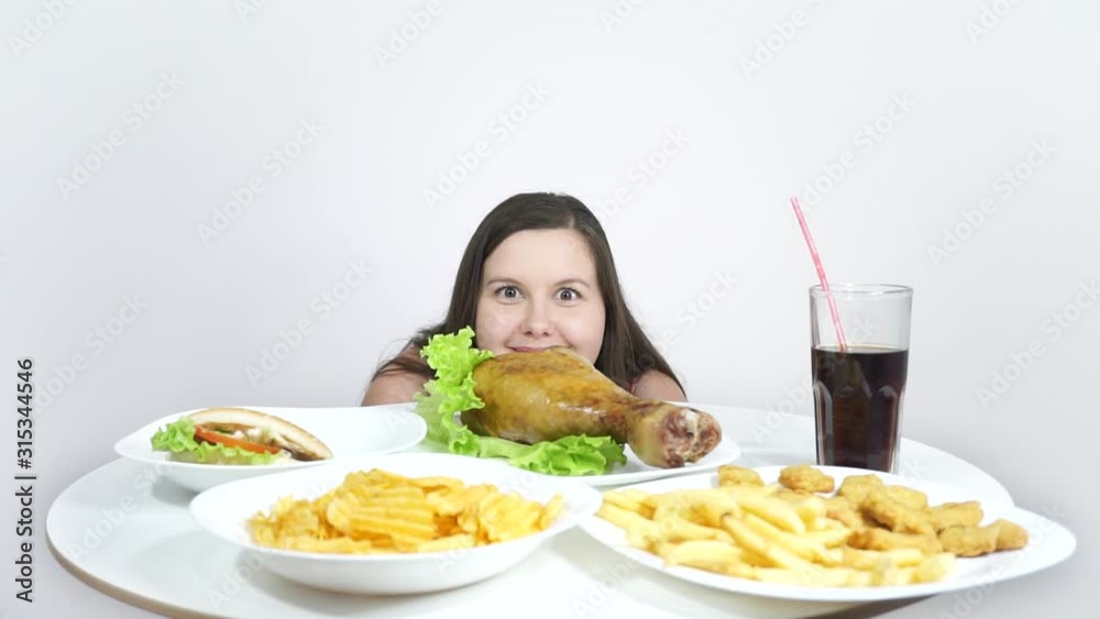 Fat Girl on a diet eating everything.Unhealthy food and overeating. Fat Girl on a diet eating everything.Unhealthy food and overeating.