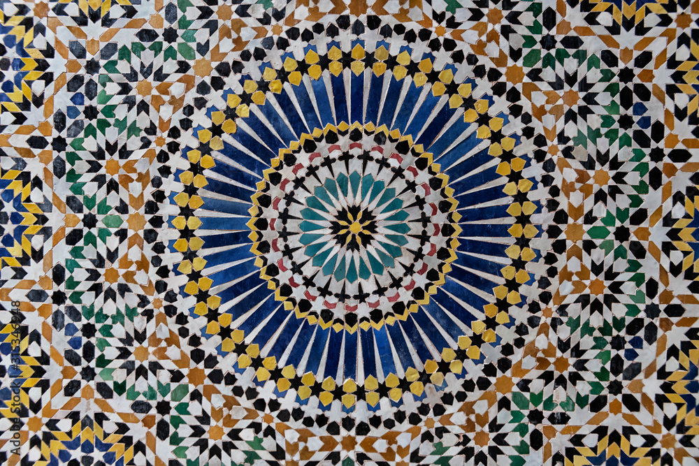 24-fold star pattern in traditional islamic geometric design from the interior of Kasbah Telouet, Morocco.