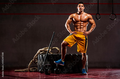 Cross Training Athlete Standing by Fitness Equipment in the gym
