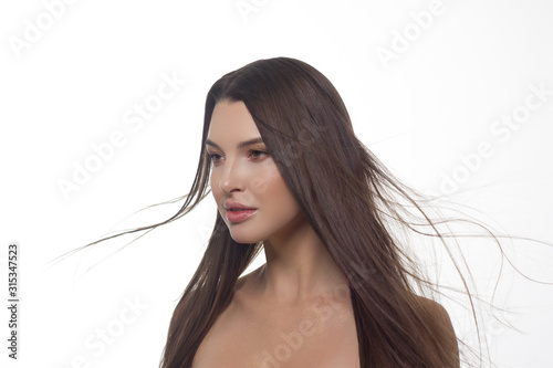 Beautiful woman with long hair. Natural gloss of lips and woman's skin. The mouth is closed. Increase in lips, cosmetology. Pink lipstick and long neck. Great summer mood