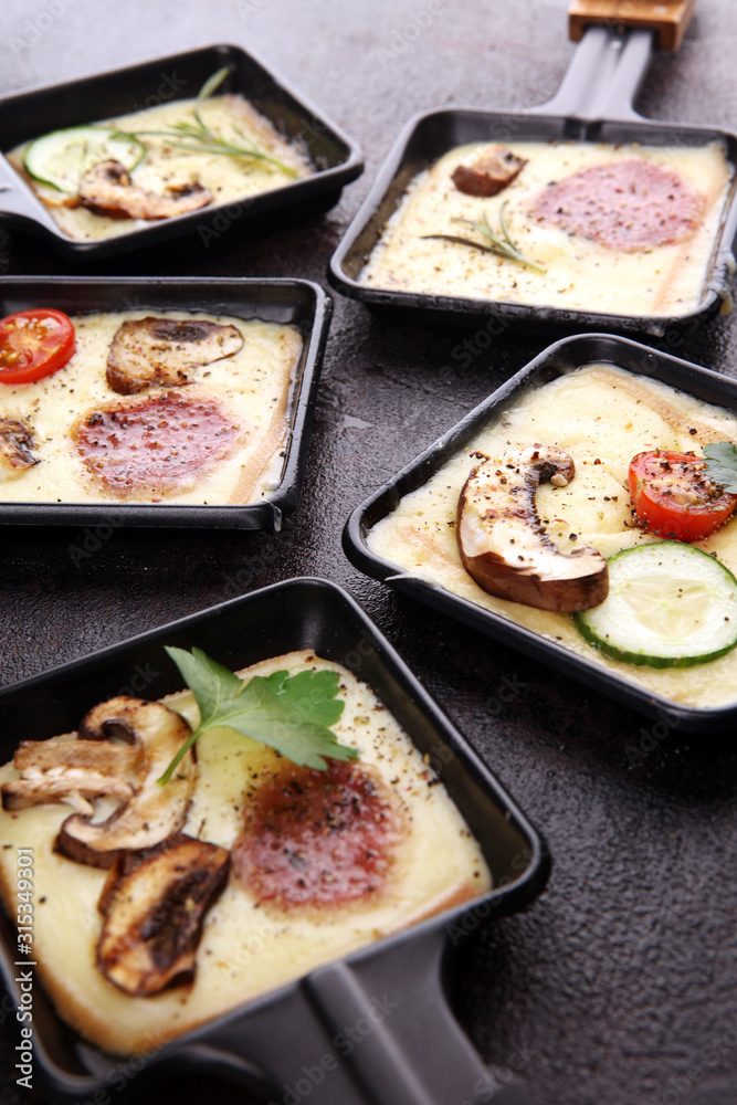 Delicious traditional Swiss melted raclette cheese on diced boiled or baked potato. Delicious traditional Swiss melted raclette cheese on diced boiled or baked potato.