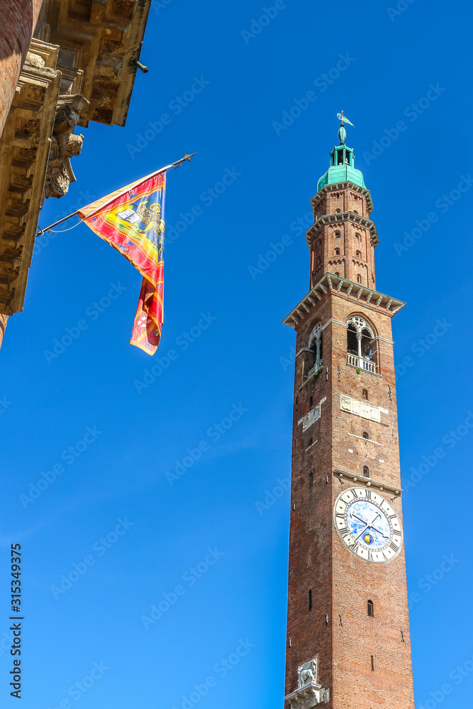 Vicenza, Italy. View of clock tower (Torre Bissara) at famous square (Piazza dei Signori) in Vicenza.
