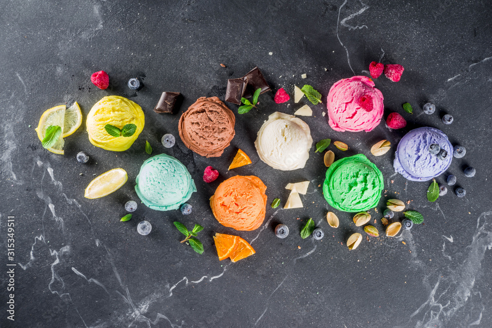 Colorful pastel ice cream with waffle cones and various flavor ingredients, black marble background, copy space top view Colorful pastel ice cream with waffle cones and various flavor ingredients, black marble background, copy space top view
