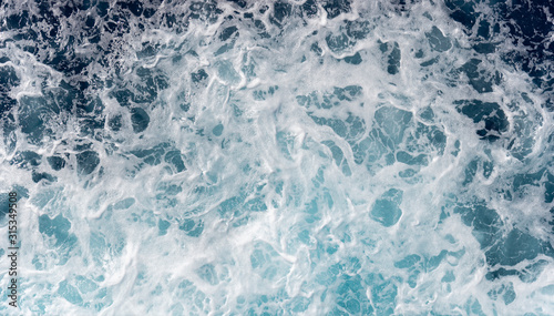 Sea foam moving in the ocean