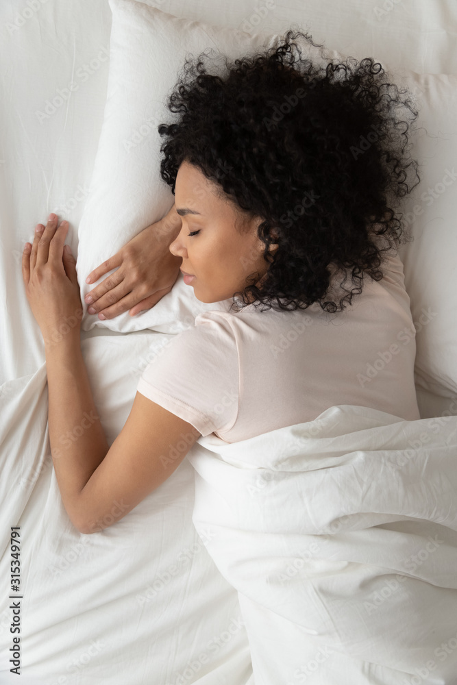 Above top vertical view african woman sleeping in bed Above top vertical view african woman sleeping in bed