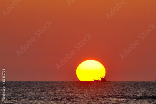 The morning sun and fishing boat.