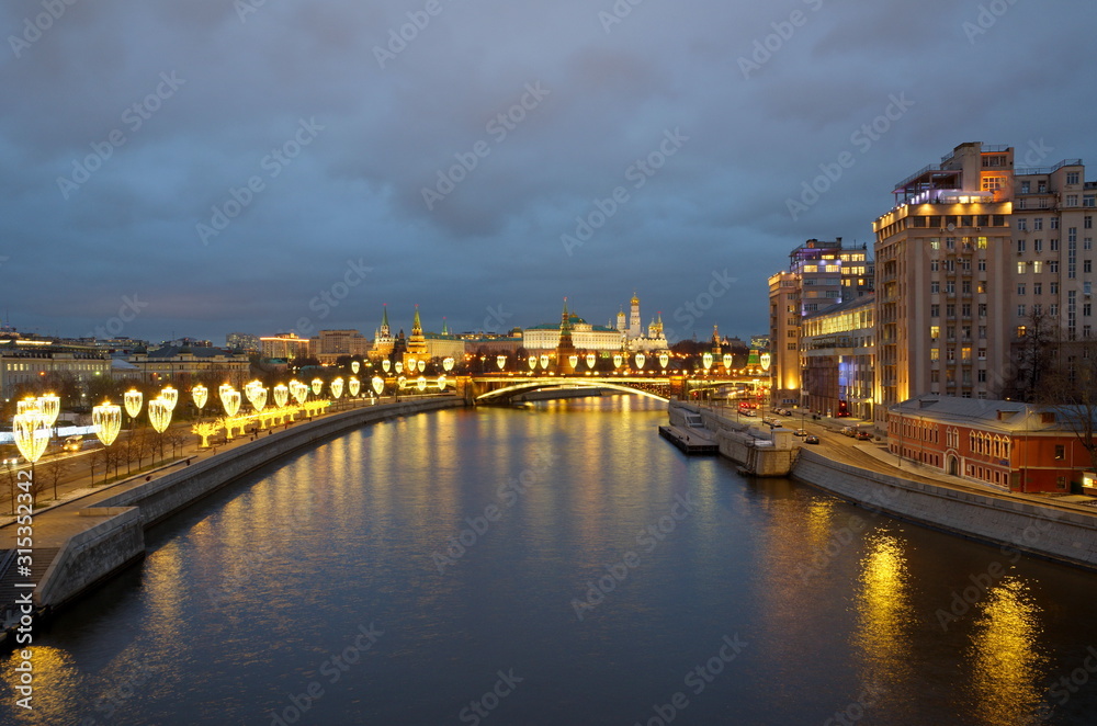Evening view of the Moscow Kremlin, Prechistenskaya and Bersenevskaya embankments with new year's illumination. Moscow, Russia
