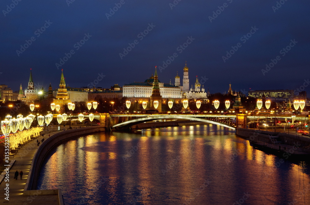 Night view of the Moscow Kremlin and the Big Stone bridge with festive illumination. Moscow, Russia