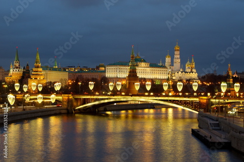 Beautiful view of the Moscow Kremlin and the Big Stone bridge with festive illumination on a winter evening. Moscow, Russia