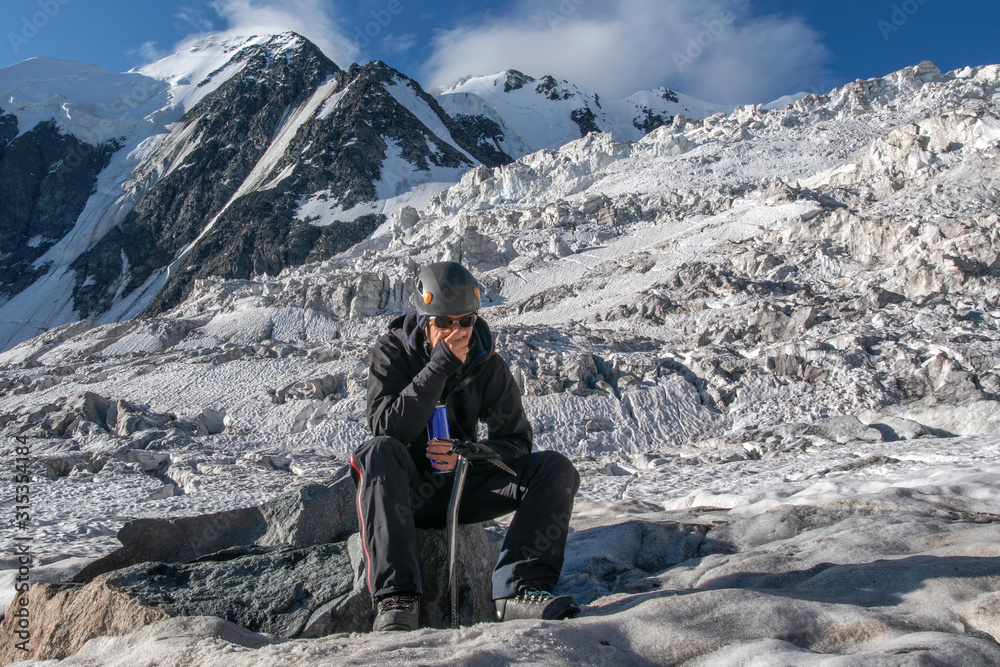 High altitude sickness. Climber breathing oxygen from the O2 tank on