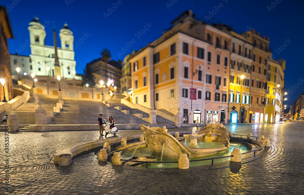Night view of Spanish Steps and  Fontana della Barcaccia in Rome, Italy.
