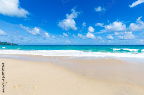 White sand beach turquoise sea water against blue sky with cloud seascape vacation background