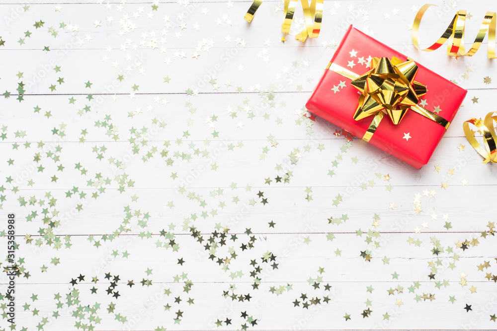 Gift boxes with gold ribbons and bows, confetti stars on a white background. Copy space Flat lay. Greeting card for birthday party, Christmas Wedding mother's Day. Gift boxes with gold ribbons and bows, confetti stars on a white background. Copy space Flat lay. Greeting card for birthday party, Christmas Wedding mother's Day.