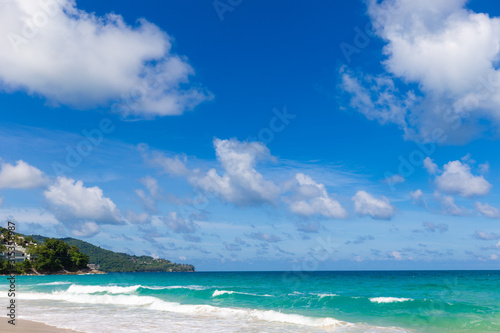 White sand beach turquoise sea water against blue sky with cloud seascape vacation background © themorningglory
