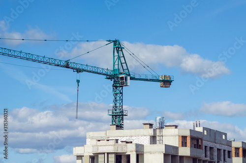 Construction site, tower crane on sky background