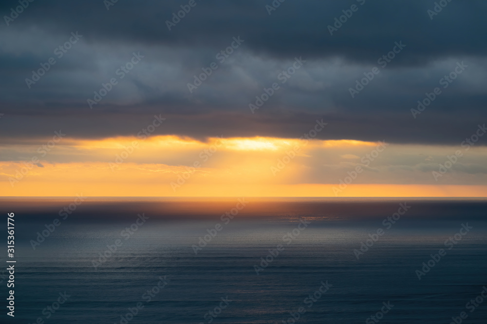 Aerial view of low clouds over Tasman sea at Piha in sunset light